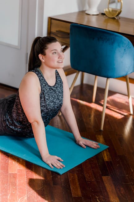 Serene senior woman doing a gentle yoga stretch in a bright room